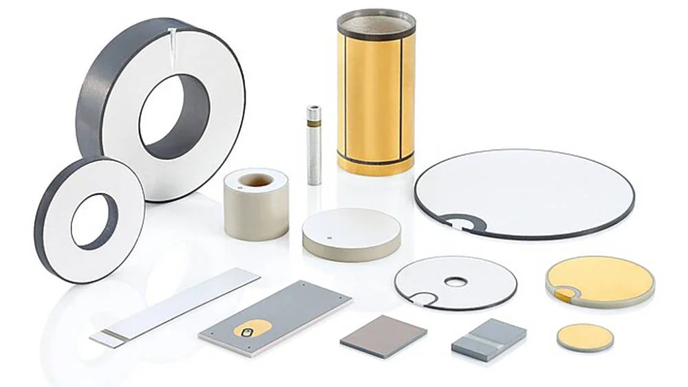 Assorted sintered piezoelectric ceramic components including discs, rings, and plates prepared for high-voltage polarization